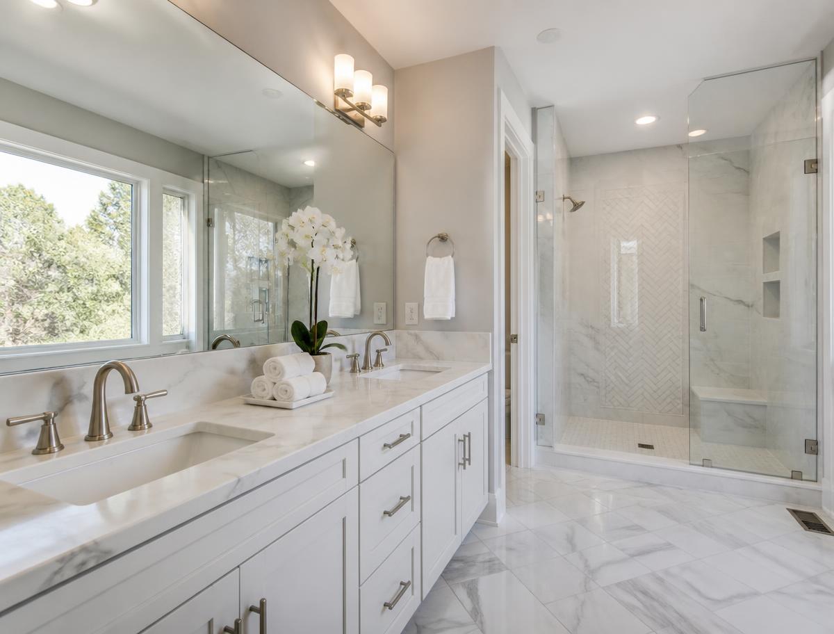 Marble double vanity, spot-free mirror and glass shower after a deep bathroom clean