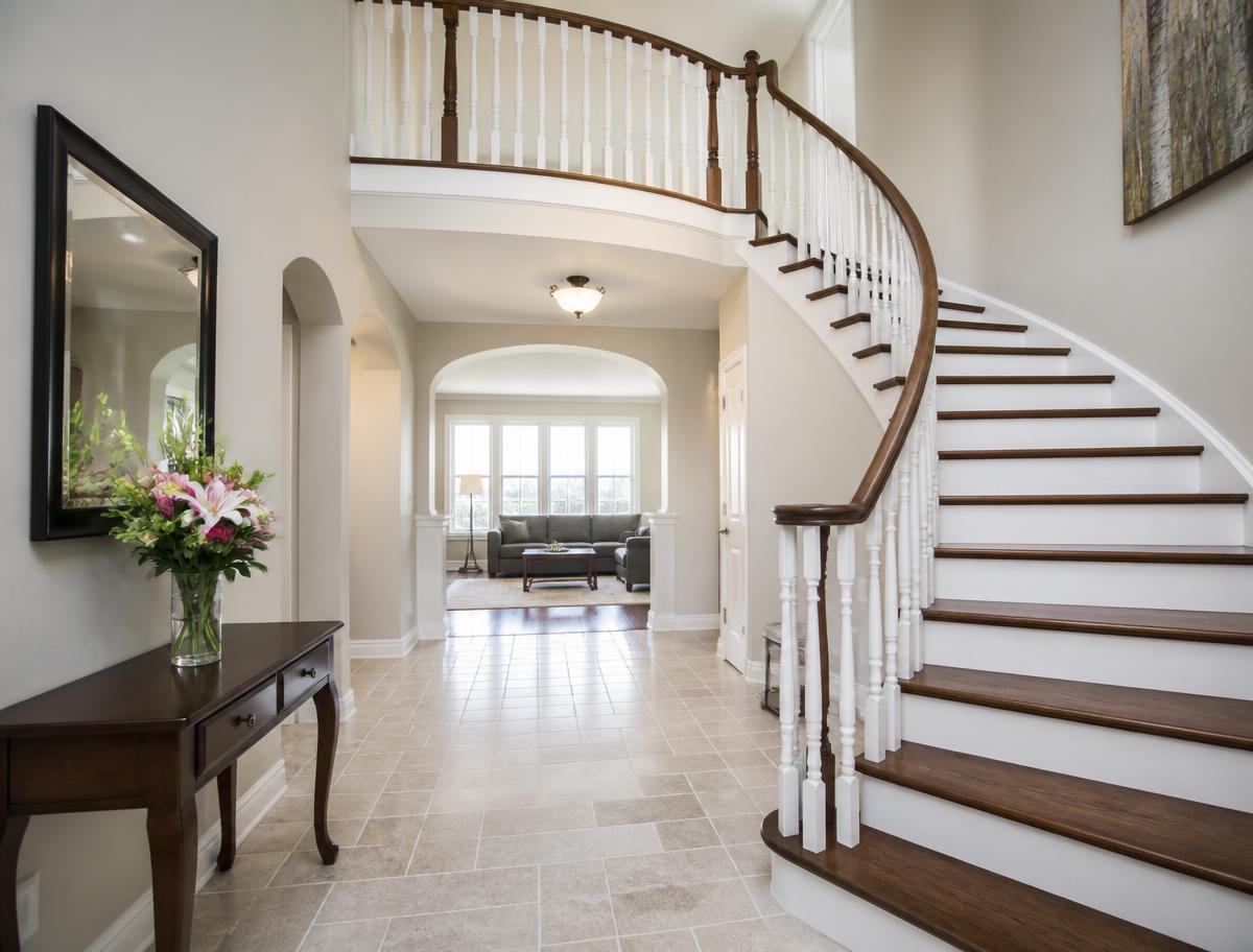 Elegant entryway and staircase with polished treads and a dust-free banister